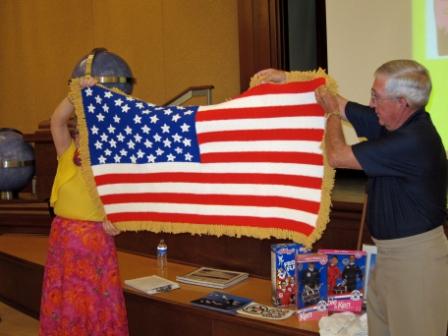 Lois Campbell and Jerry Jones show the American Flag donated by Tom Bourchard.jpg