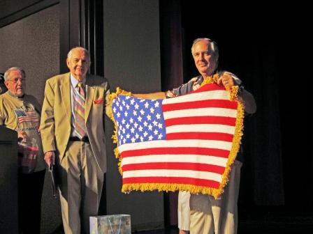 Tom Bouchard showing the American Flag Afghan his Mother made for the raffle.jpg